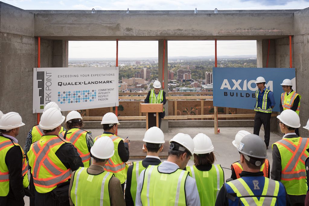 Mohammed Esfahani, president of Qualex-Landmark, speaks at the topping-off ceremony on the 34th floor of Park Point, while Mike McDonough, vice-president, Axiom Builders, and Tony Wai, lead architect, IBI Group, look on. The project is expected to be move-in ready by summer 2018.